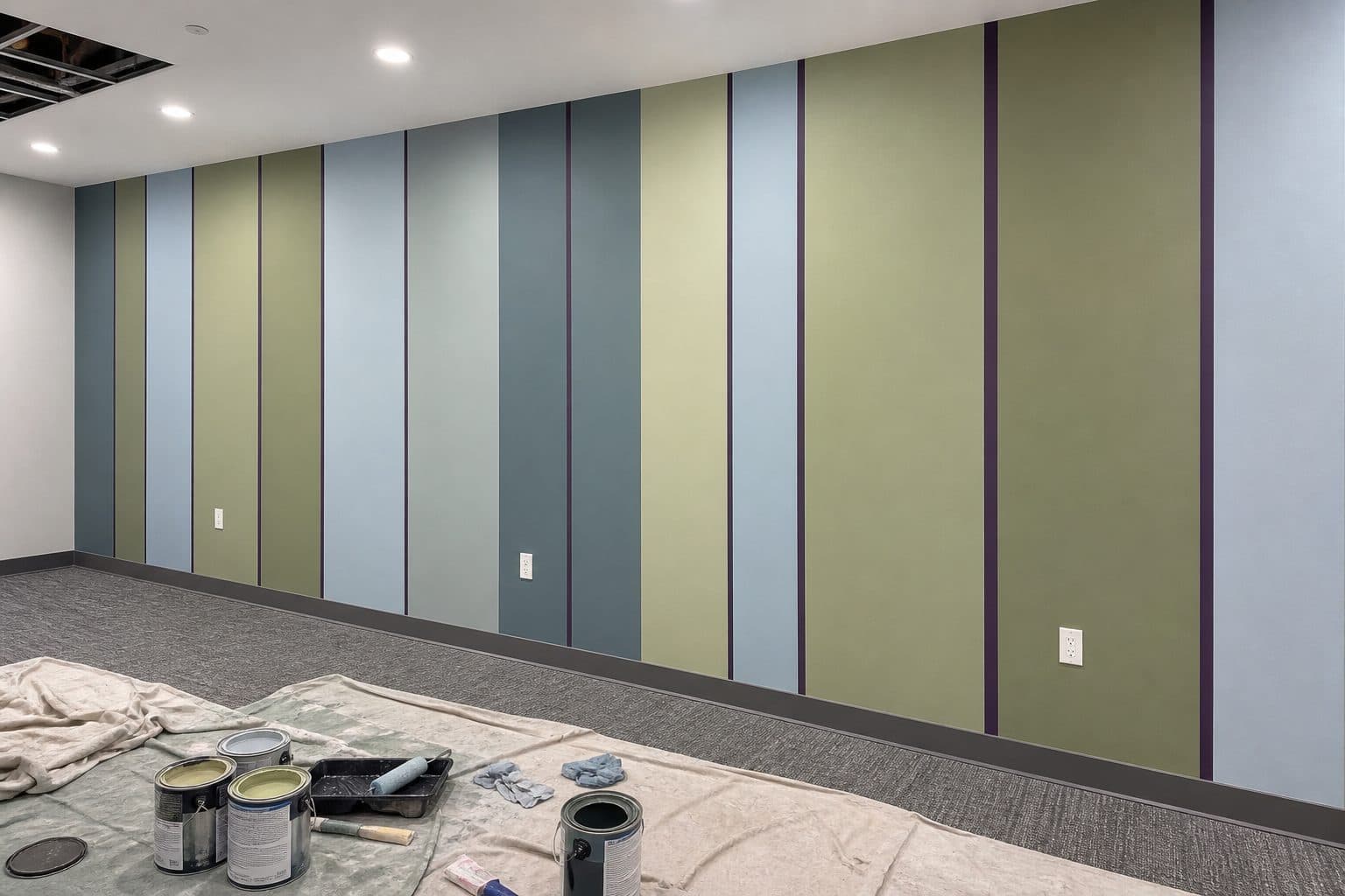 Hand-painted vertical stripes in muted green, blue and cream in a Polygon show home